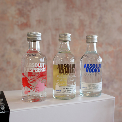 3 bottle of aboslut vodka. miniature bottles stood on gift set box.