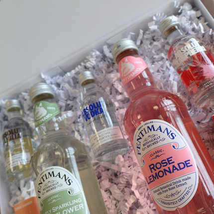 close up of absolut vodka gift set. 2 custom mixer bottles and 3 aboslut miniatures.